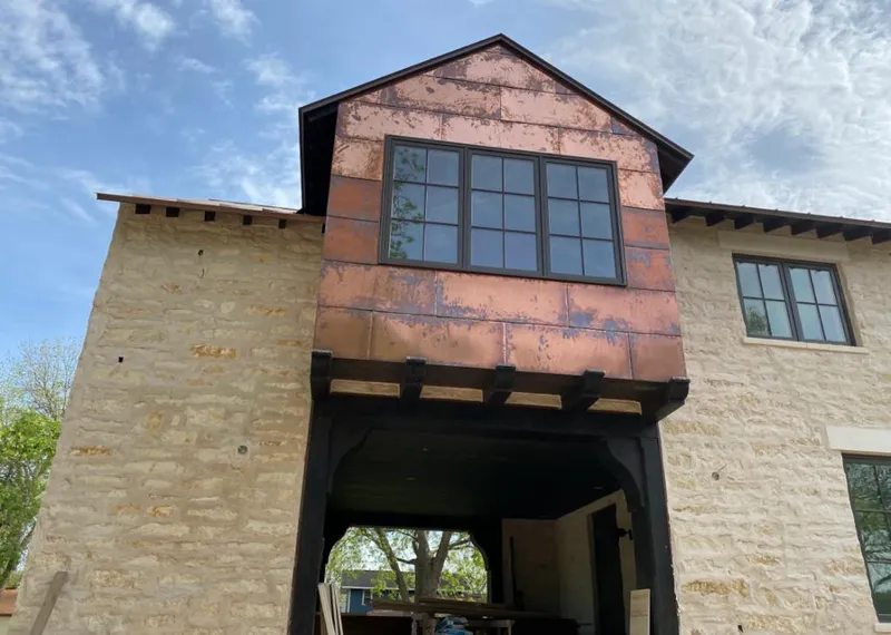 Copper metal panel facade on a stone building for Metal Roof Coating in Evergreen