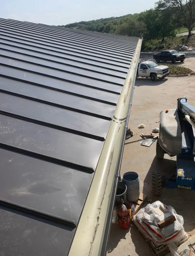 Standing seam panel and gutter detail on a metal roofing jobsite in Evergreen